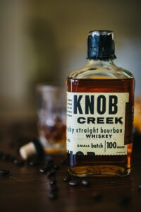 a bottle of knob creek whiskey sitting on a table